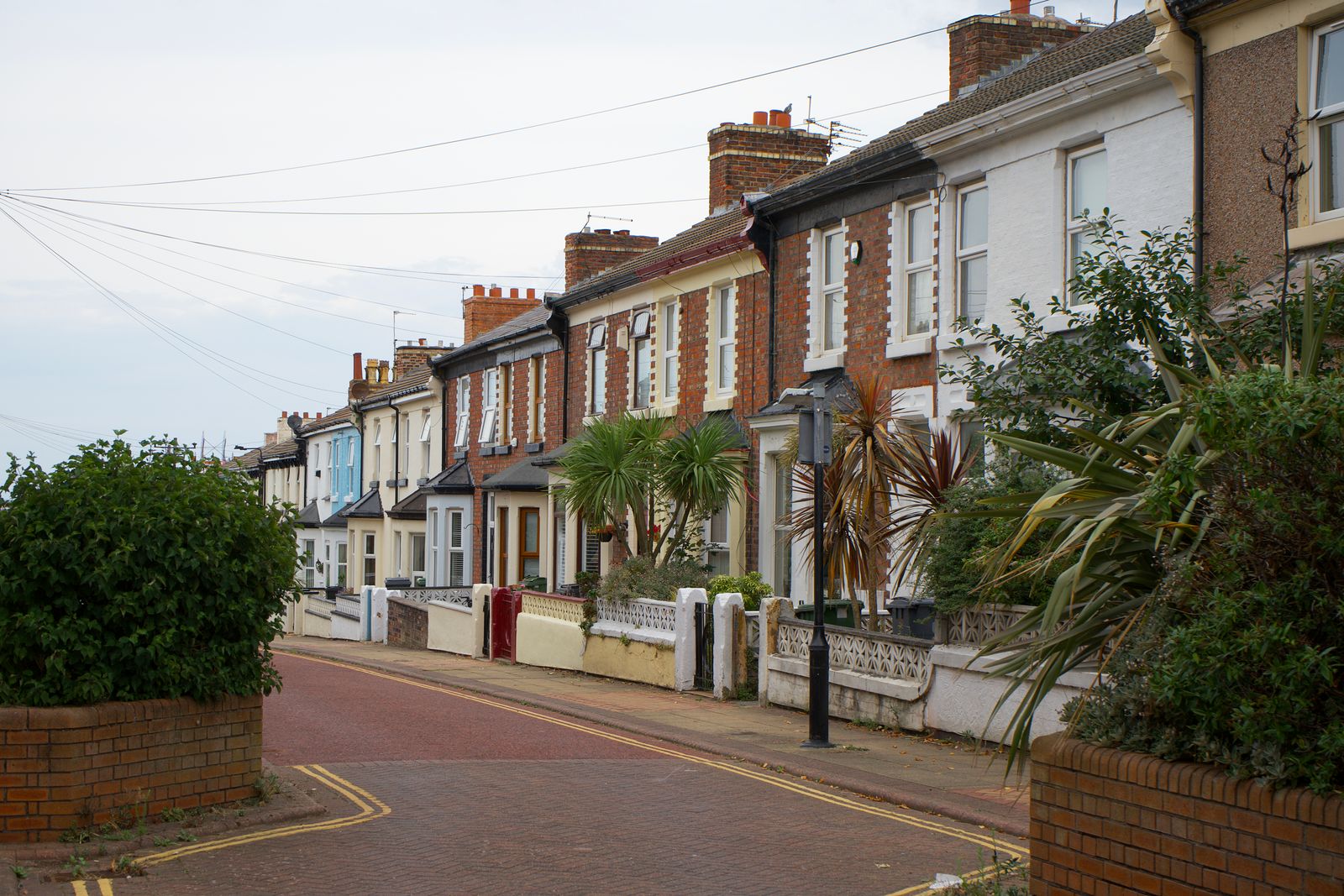A quiet street of brick terraced houses in an English town